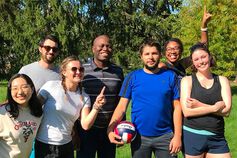 A happy and diverse group of IU students, faculty, and staff poses outdoors.